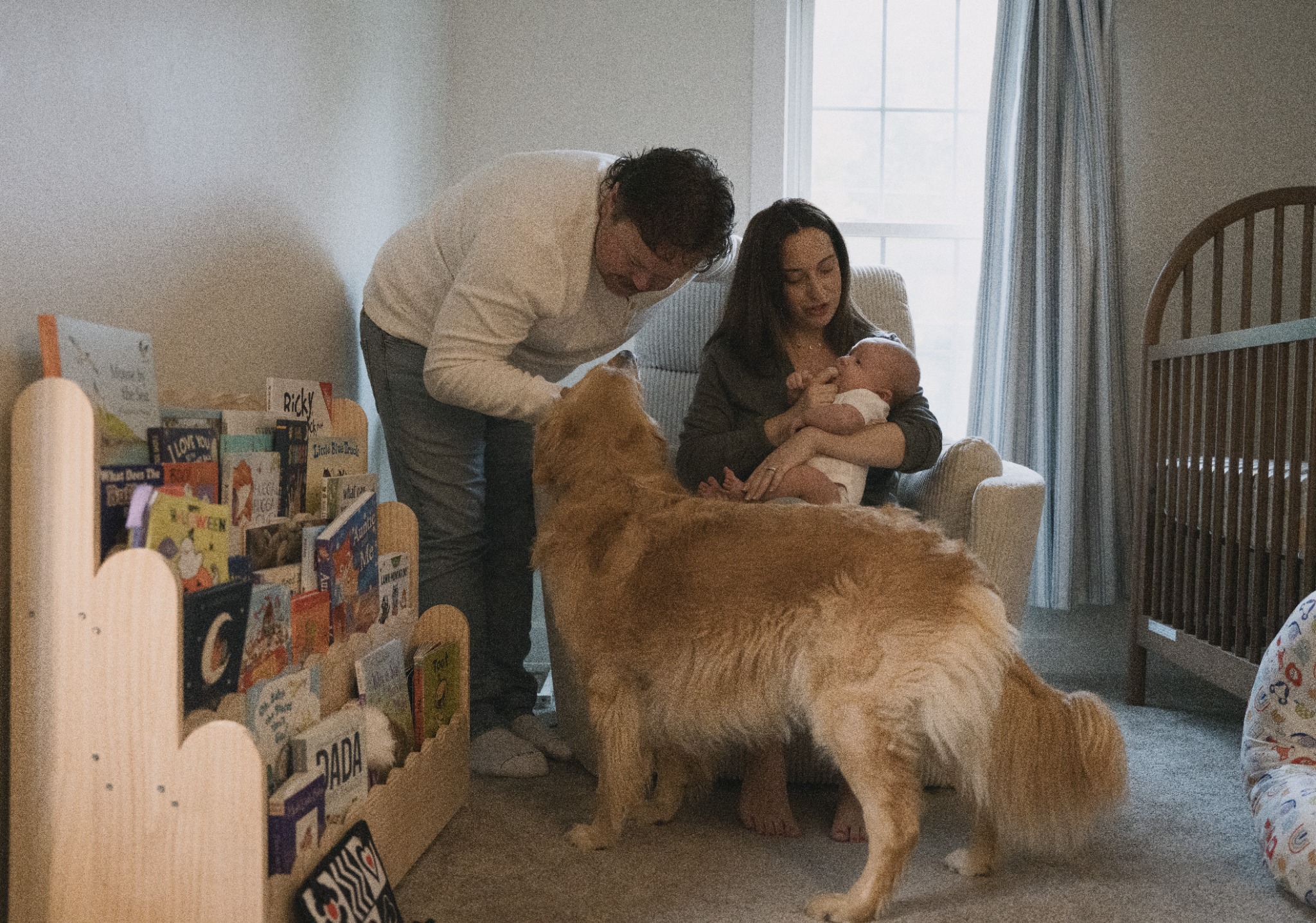 Parents with their baby and dog in the nursery